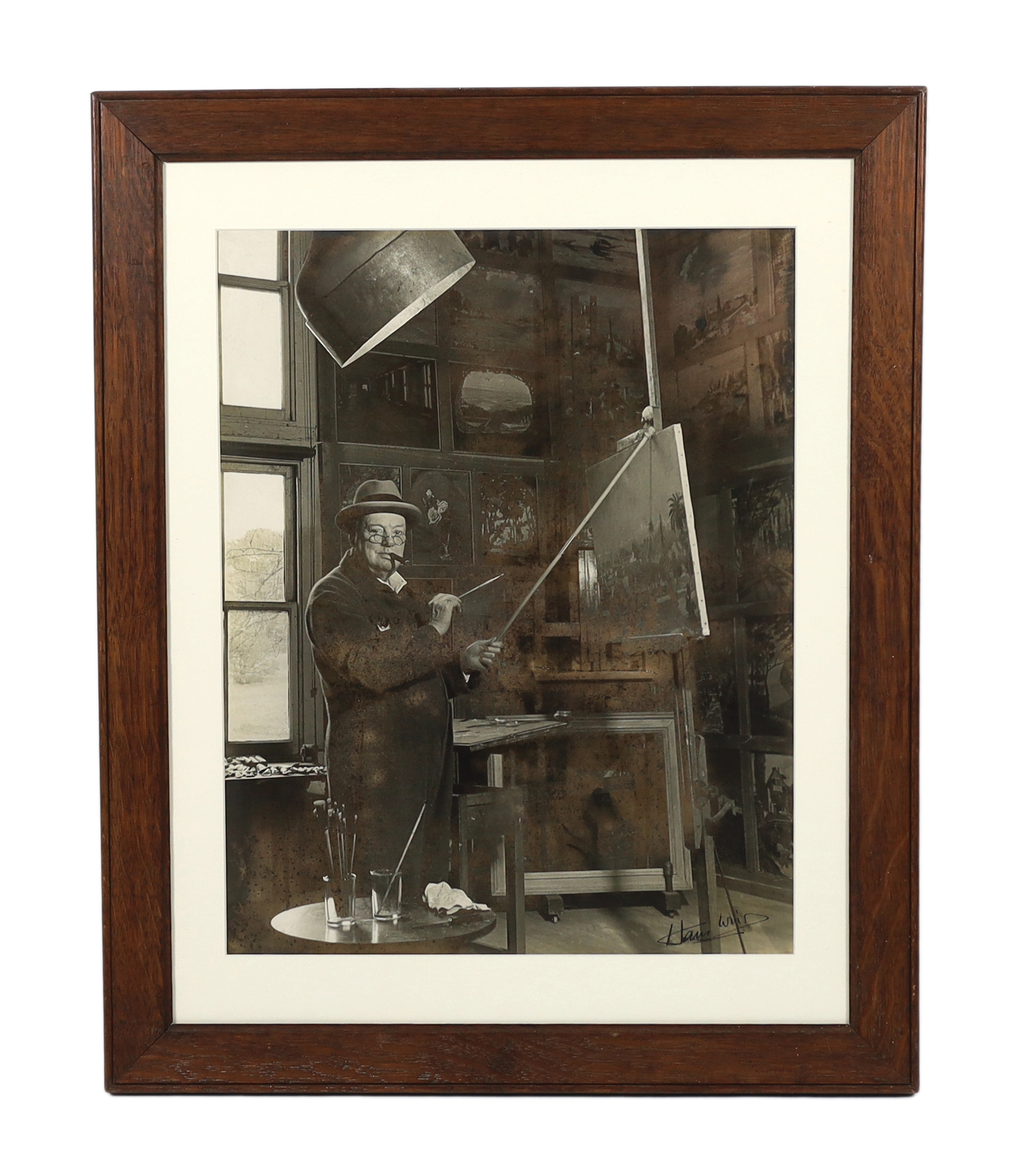 Churchill, Winston S. (1874-1965) - Sir Winston Churchill at his easel in his studio at Chartwell, a black and white photograph